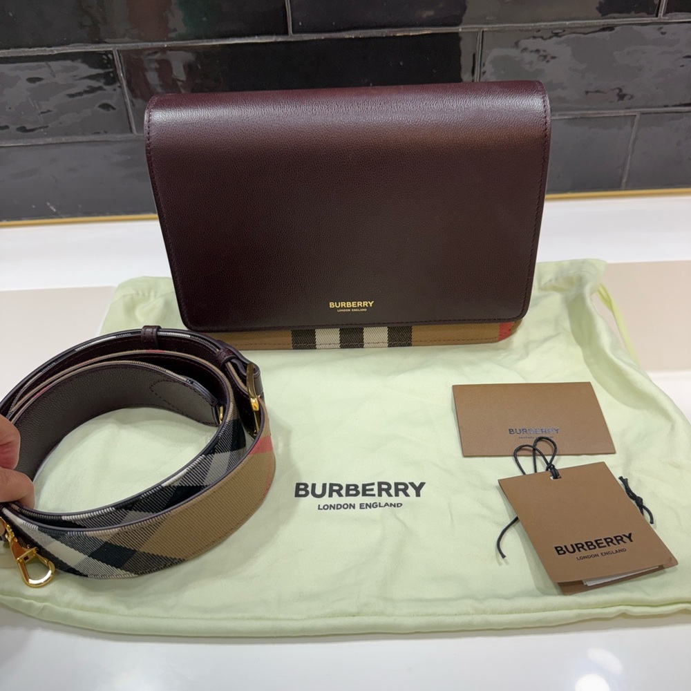 Burberry Oxblood Leather Bag with Flap Closure and removable strap.